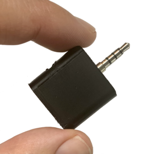 Two fingers holding a RECAP unit for call recording